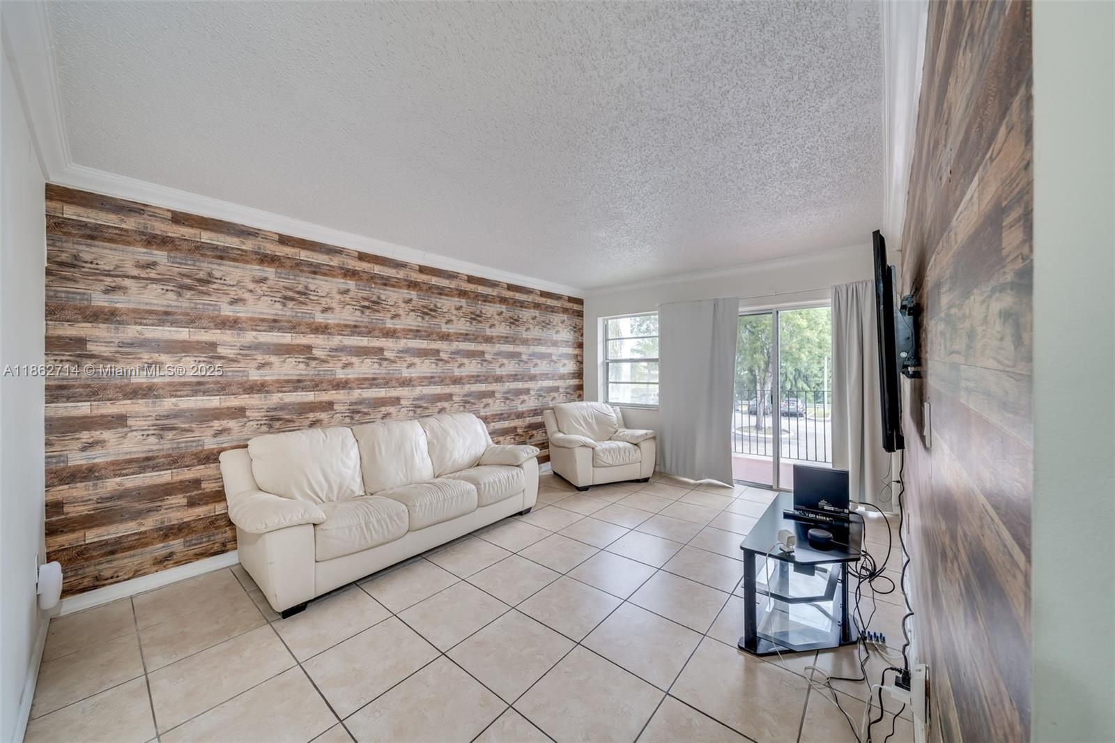 1221 Southwest 122nd Avenue, Unit 215 Miami, FL 33184 - Photo 21 of 57 a living room with furniture and a fireplace