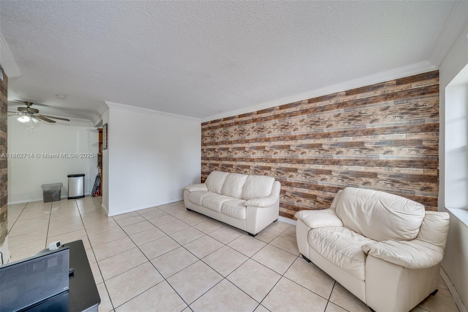 1221 Southwest 122nd Avenue, Unit 215 Miami, FL 33184 - Photo 23 of 57 a living room with furniture and a fireplace