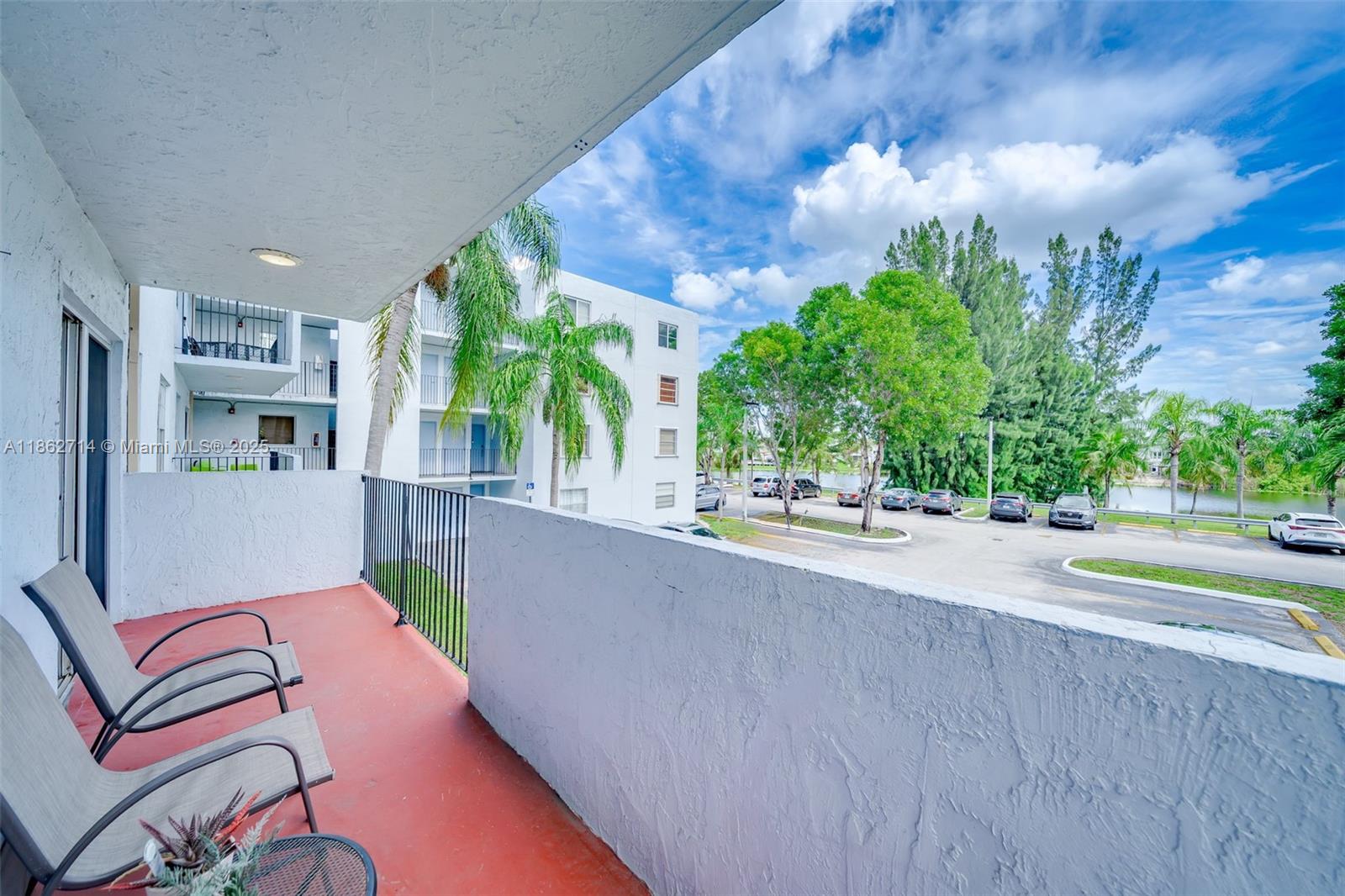 1221 Southwest 122nd Avenue, Unit 215 Miami, FL 33184 - Photo 28 of 57 a view of swimming pool with outdoor seating and plants