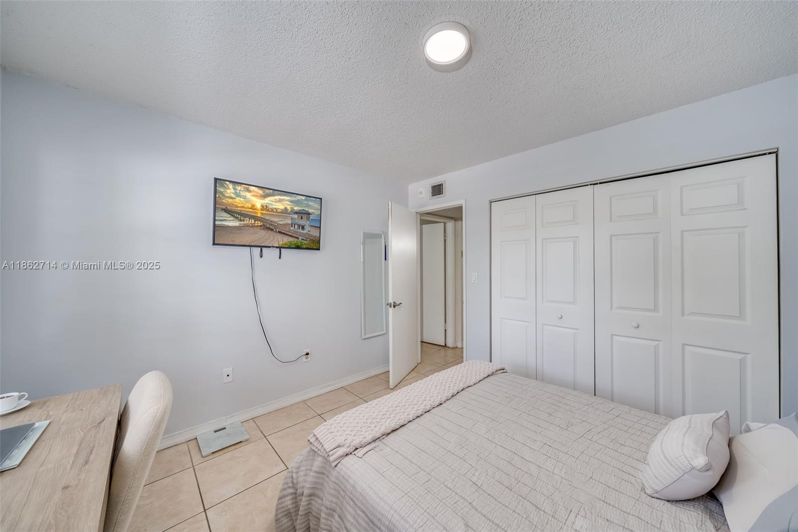 1221 Southwest 122nd Avenue, Unit 215 Miami, FL 33184 - Photo 34 of 57 a bedroom with a bed and a couch