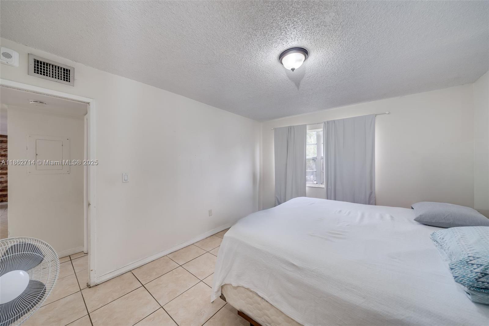 1221 Southwest 122nd Avenue, Unit 215 Miami, FL 33184 - Photo 37 of 57 a bedroom with a bed and a potted plant