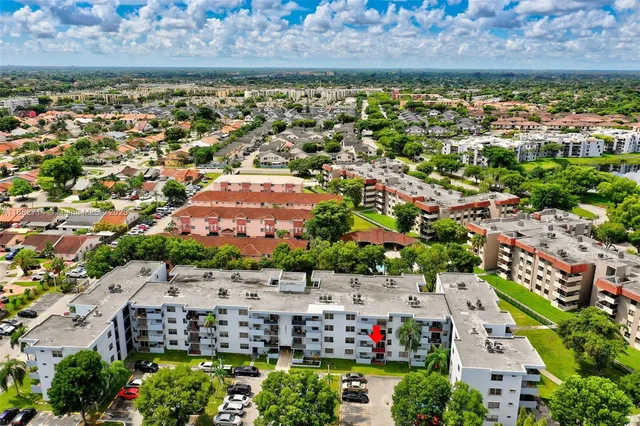 an aerial view of residential houses with outdoor space and river