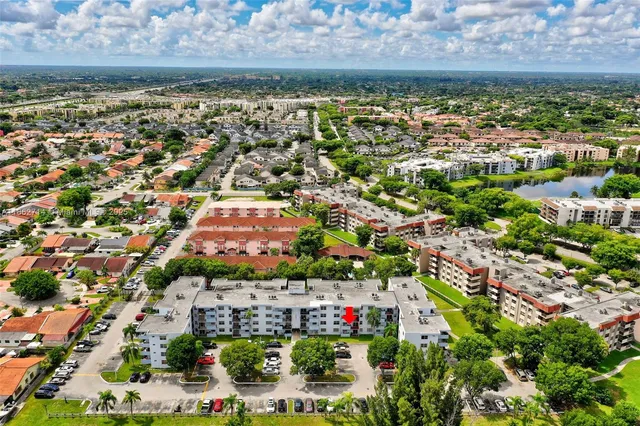 an aerial view of residential building and lake
