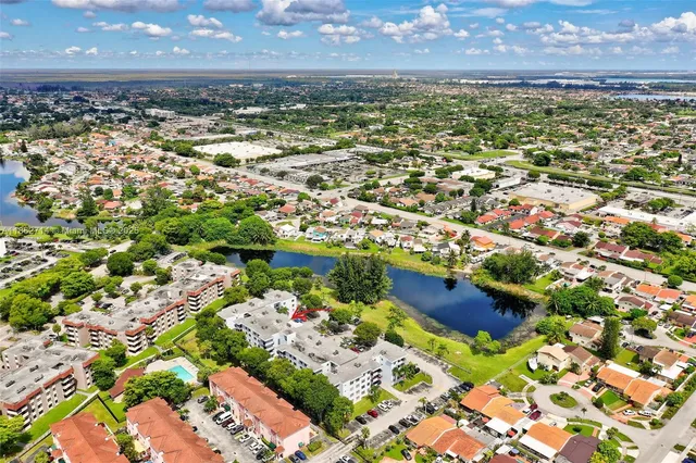 a view of a city with lots of residential buildings ocean and mountain view in back