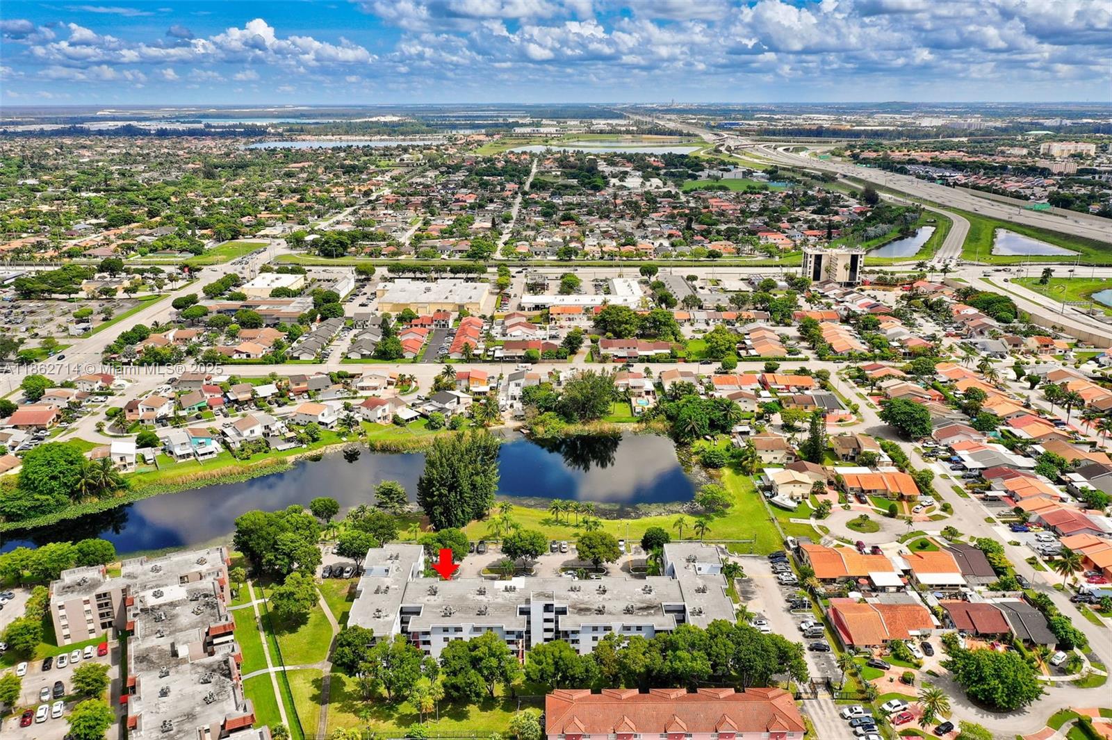 1221 Southwest 122nd Avenue, Unit 215 Miami, FL 33184 - Photo 47 of 57 an aerial view of residential building with outdoor space