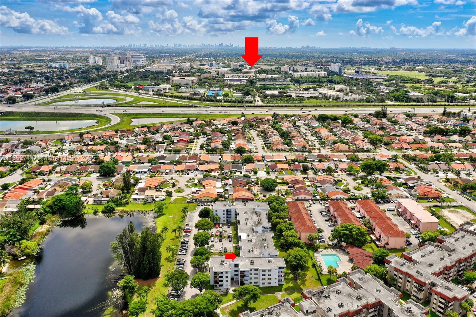 1221 Southwest 122nd Avenue, Unit 215 Miami, FL 33184 - Photo 49 of 57 an aerial view of residential building and lake