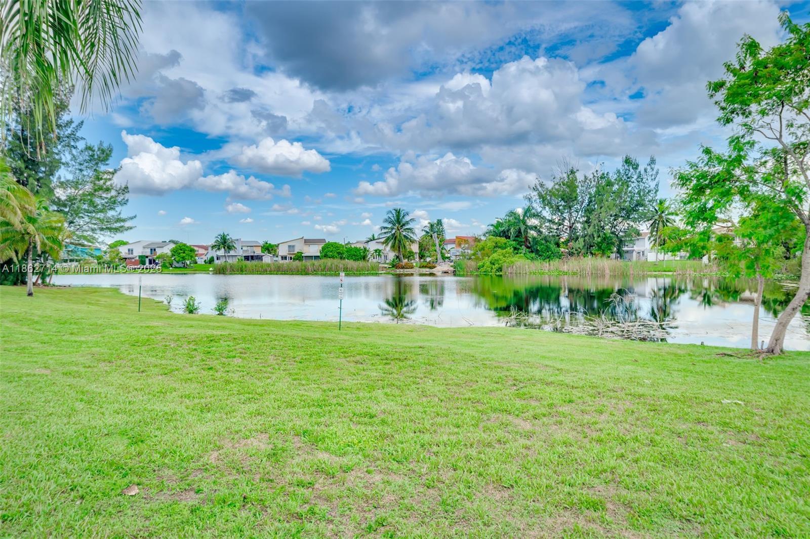1221 Southwest 122nd Avenue, Unit 215 Miami, FL 33184 - Photo 6 of 57 a view of a big yard with plants and large trees