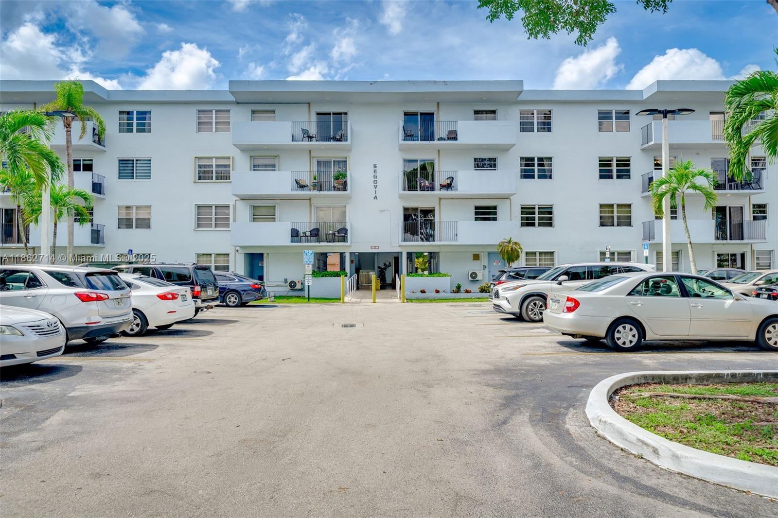1221 Southwest 122nd Avenue, Unit 215 Miami, FL 33184 - Photo 9 of 57 a car parked in front of a building
