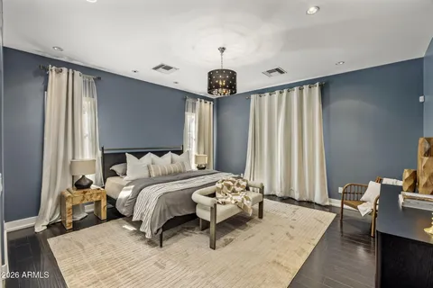 a bedroom with a bed and a chandelier