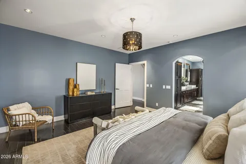 a bedroom with a bed and a chandelier