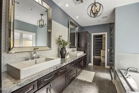 a spacious bathroom with a double vanity sink and a mirror