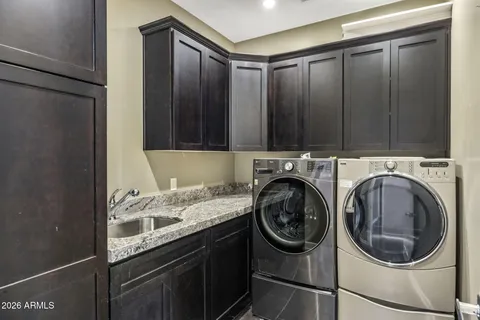 a utility room with sink dryer and washer