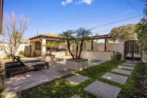 a view of a house with backyard and sitting area