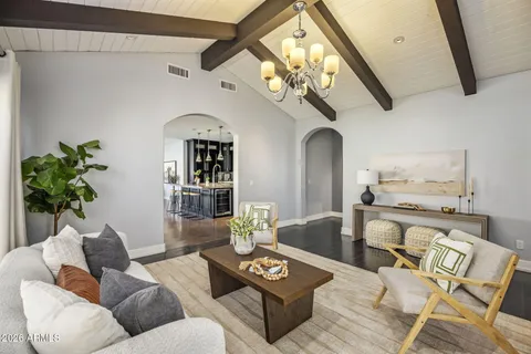 a living room with furniture and a chandelier