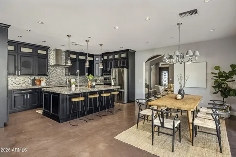 a kitchen with stainless steel appliances granite countertop a stove and a refrigerator