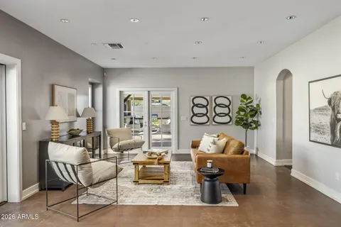 a living room with furniture and wooden floor