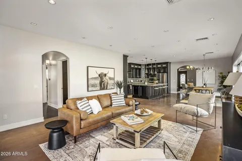 a living room with furniture and view of kitchen