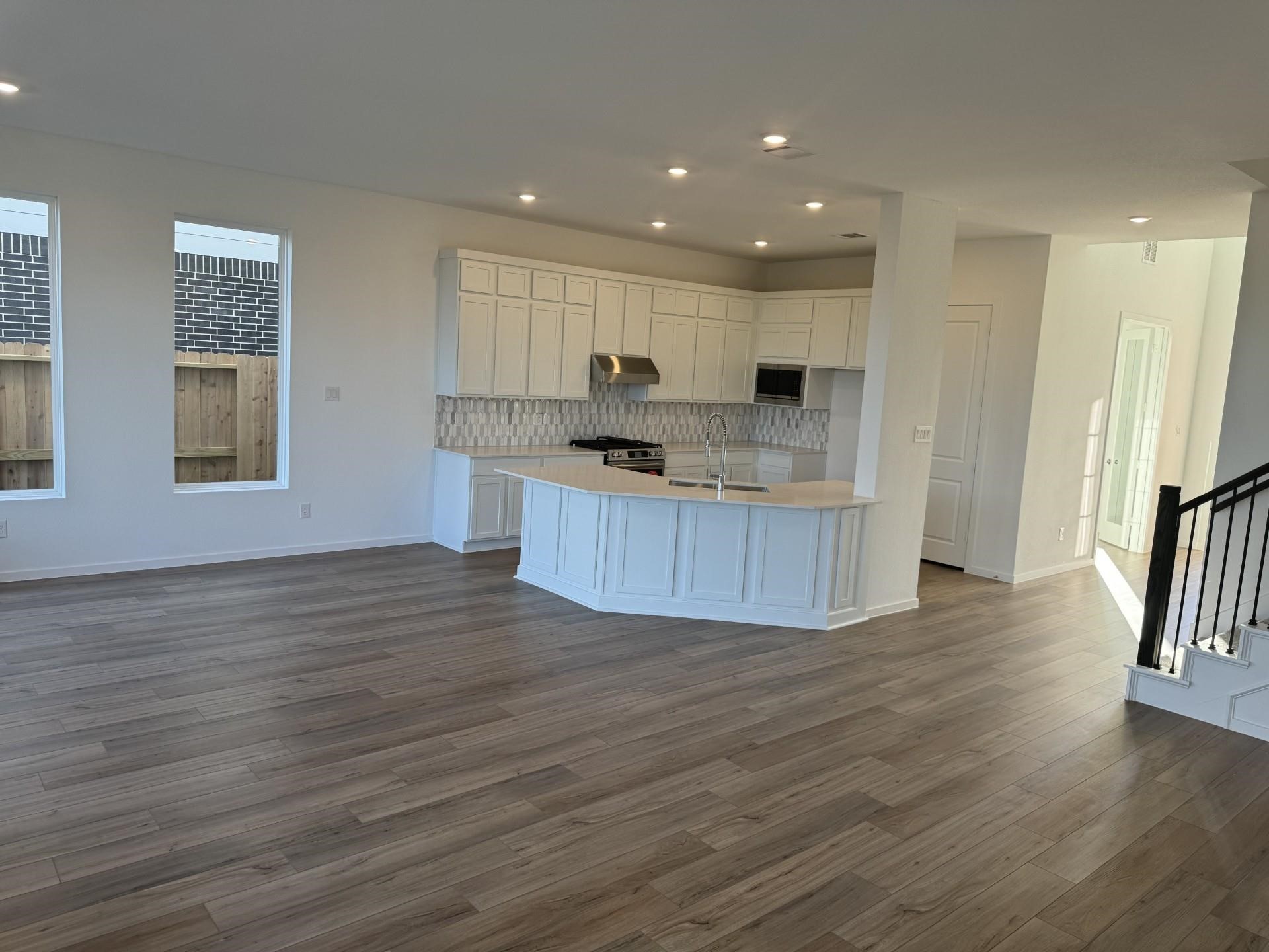 8306 Holly Blue Drive Rosharon, TX 77583 - Photo 3 of 25 a kitchen with stainless steel appliances granite countertop a sink stove and wooden floor