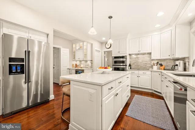 a large kitchen with lots of counter space and stainless steel appliances