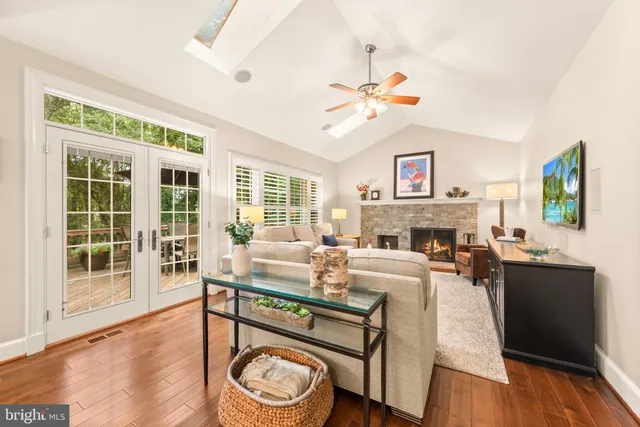 a living room with furniture a fireplace and a window