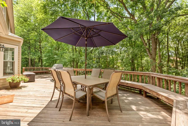 a view of roof deck with chairs and wooden floor
