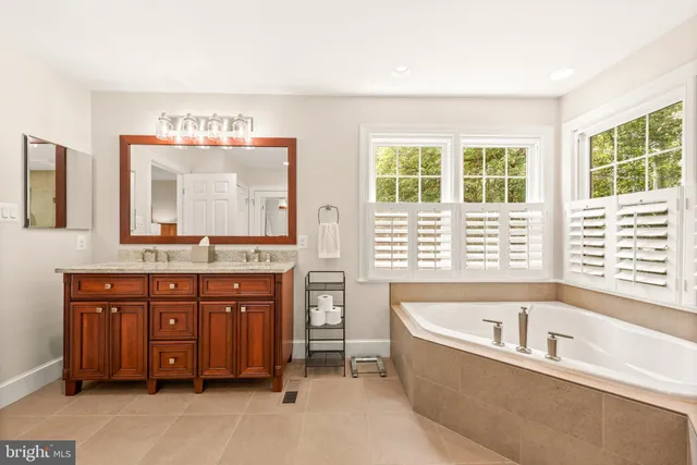 a bathroom with a sink double vanity and a bathtub
