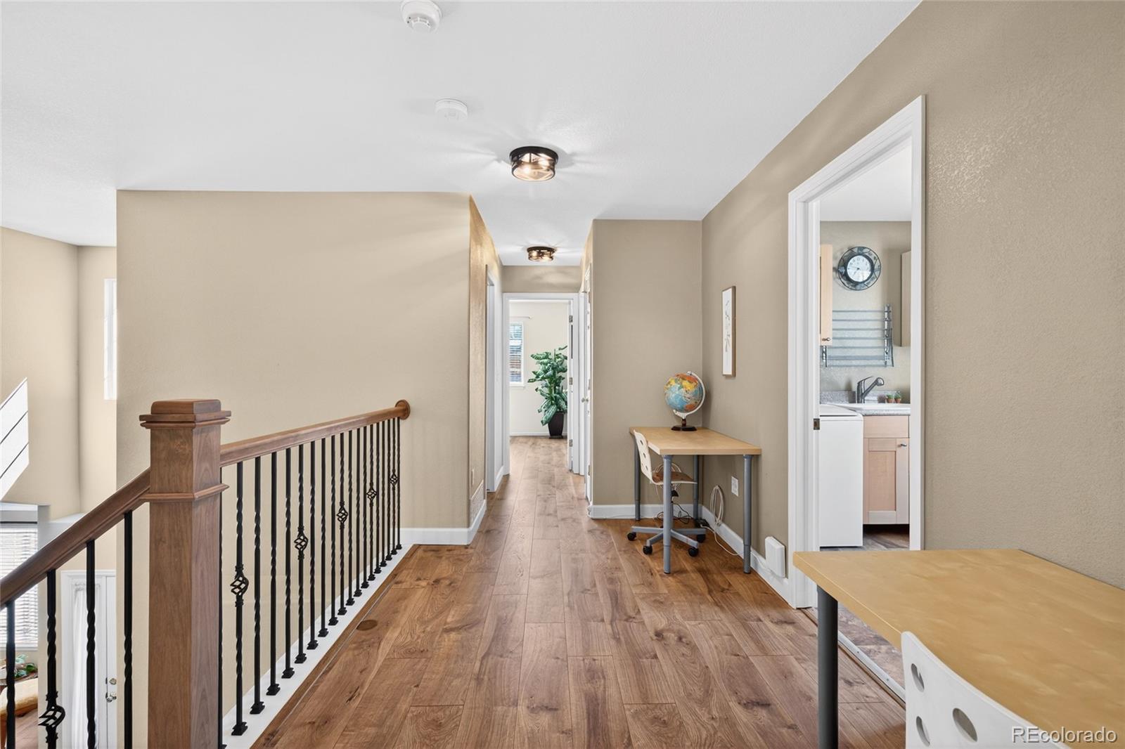 747 West Sparrow Hawk Drive Highlands Ranch, CO 80129 - Photo 12 of 50 a view of a hallway to a livingroom with furniture and wooden floor