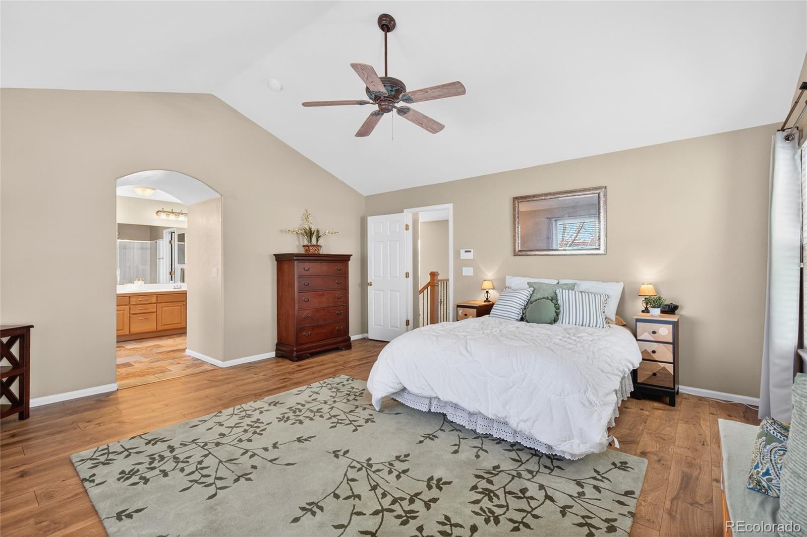 747 West Sparrow Hawk Drive Highlands Ranch, CO 80129 - Photo 13 of 50 a bedroom with a bed and a chandelier
