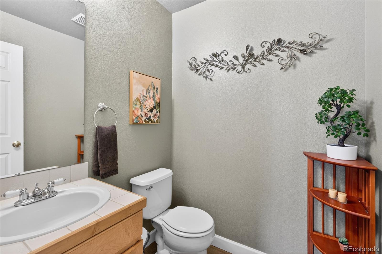 747 West Sparrow Hawk Drive Highlands Ranch, CO 80129 - Photo 23 of 50 a bathroom with a sink mirror vanity and toilet