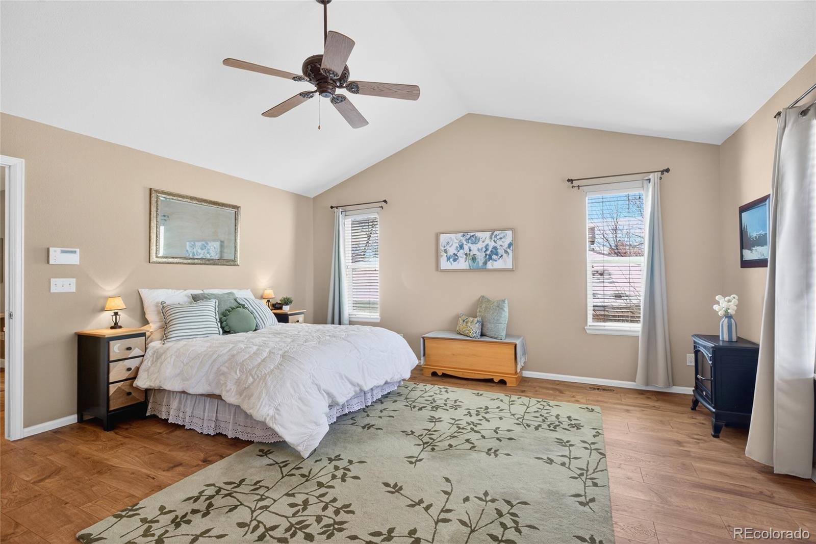 747 West Sparrow Hawk Drive Highlands Ranch, CO 80129 - Photo 27 of 50 a bedroom with a bed and wooden floor