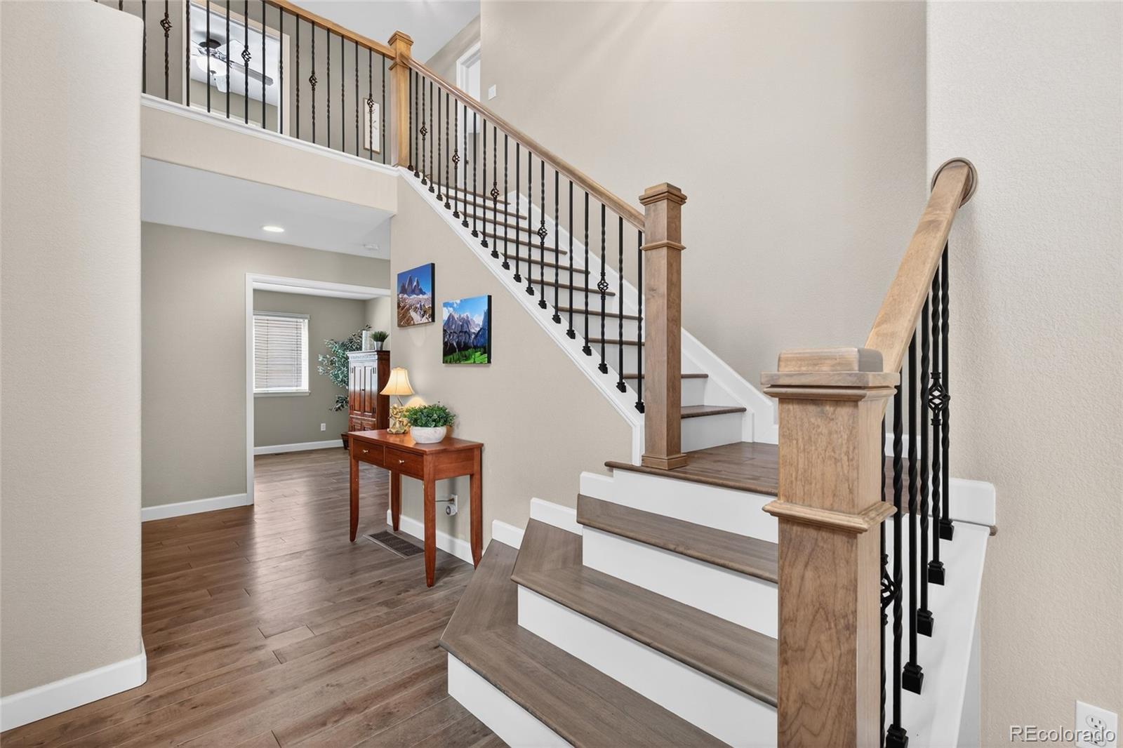 747 West Sparrow Hawk Drive Highlands Ranch, CO 80129 - Photo 3 of 50 a view of entryway and hall with wooden floor