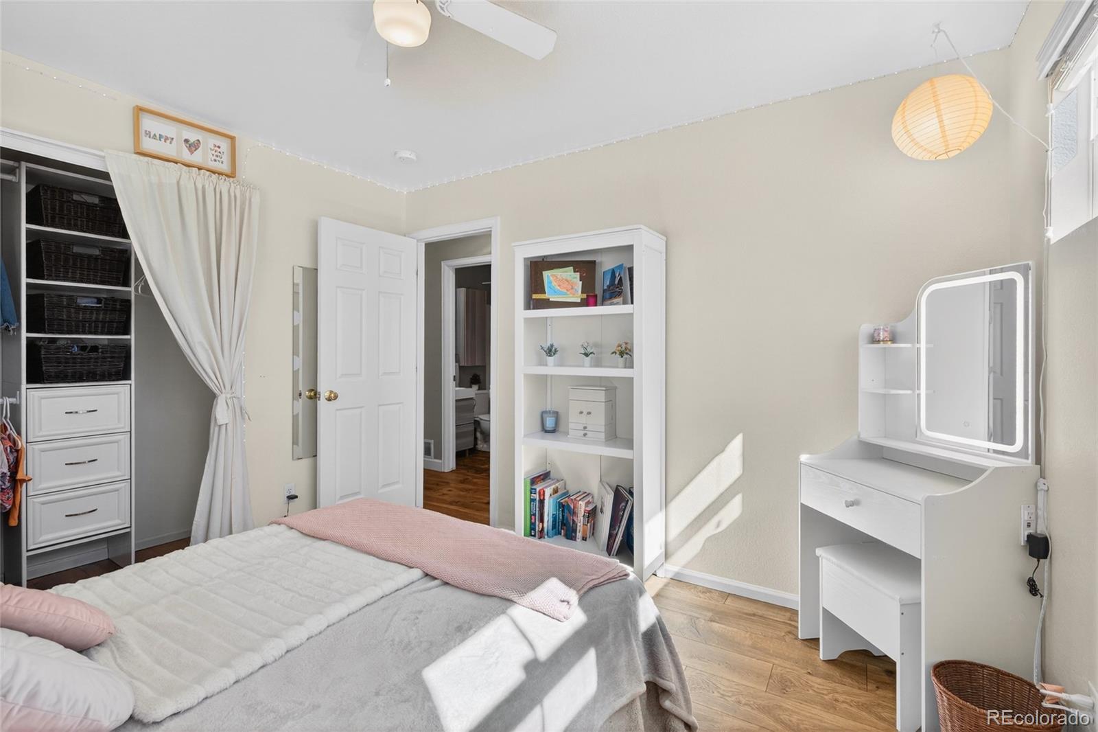 747 West Sparrow Hawk Drive Highlands Ranch, CO 80129 - Photo 32 of 50 a bedroom with a bed and a flat tv screen on dresser