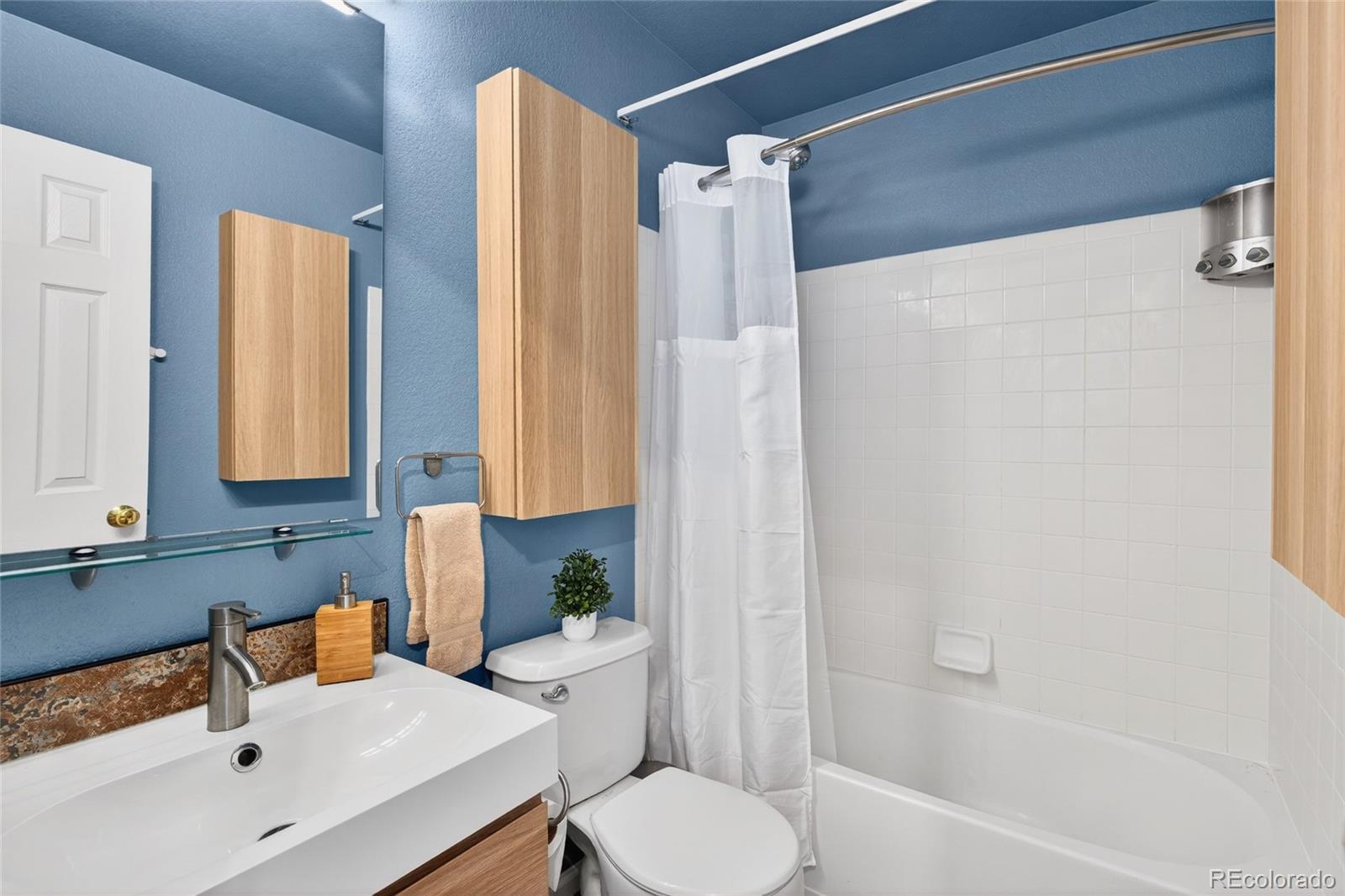 747 West Sparrow Hawk Drive Highlands Ranch, CO 80129 - Photo 33 of 50 a bathroom with a sink toilet and shower