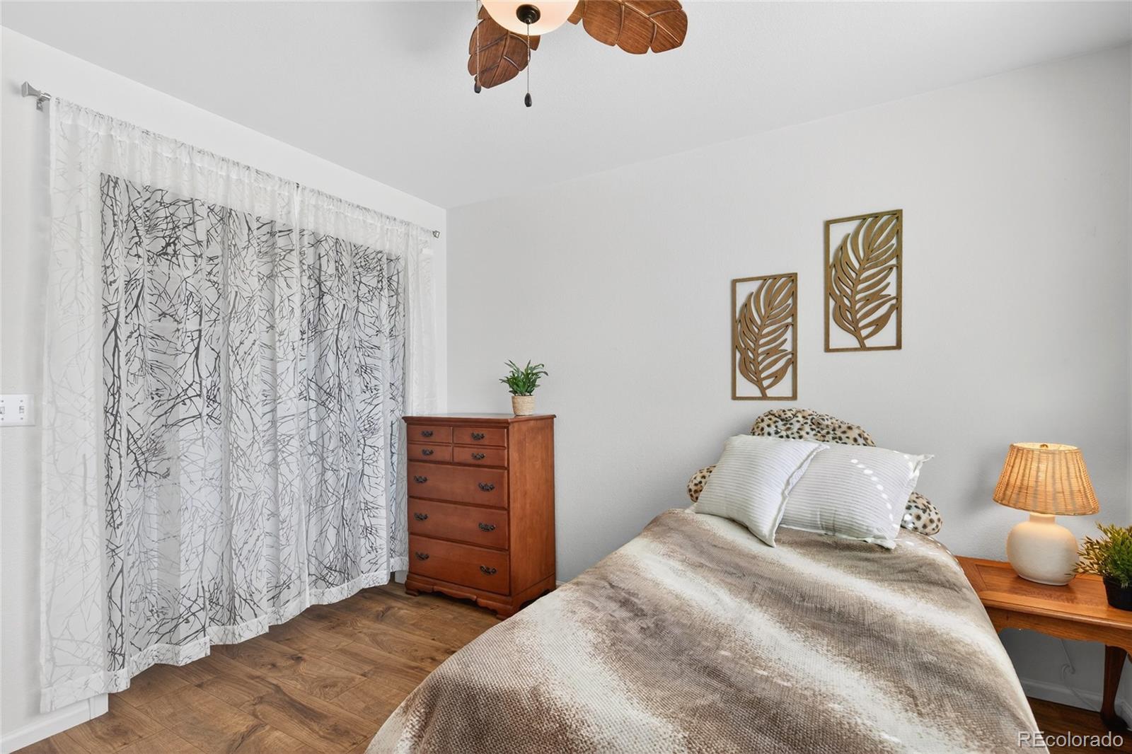 747 West Sparrow Hawk Drive Highlands Ranch, CO 80129 - Photo 34 of 50 a bedroom with a bed and a painting on the wall