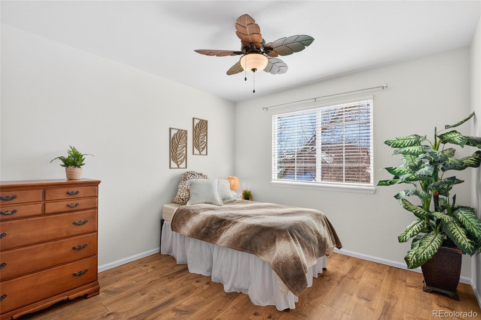 747 West Sparrow Hawk Drive Highlands Ranch, CO 80129 - Photo 35 of 50 a bedroom with a bed and a potted plant