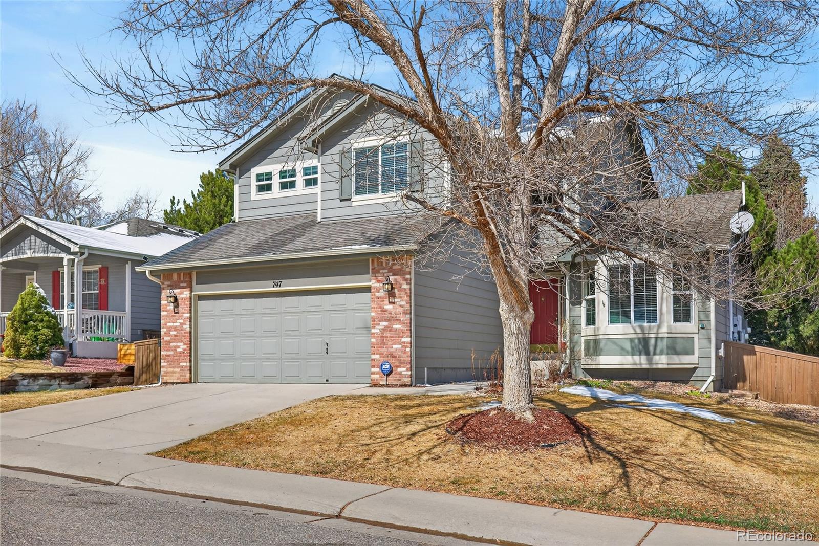 747 West Sparrow Hawk Drive Highlands Ranch, CO 80129 - Photo 47 of 50 a front view of a house with a yard and garage