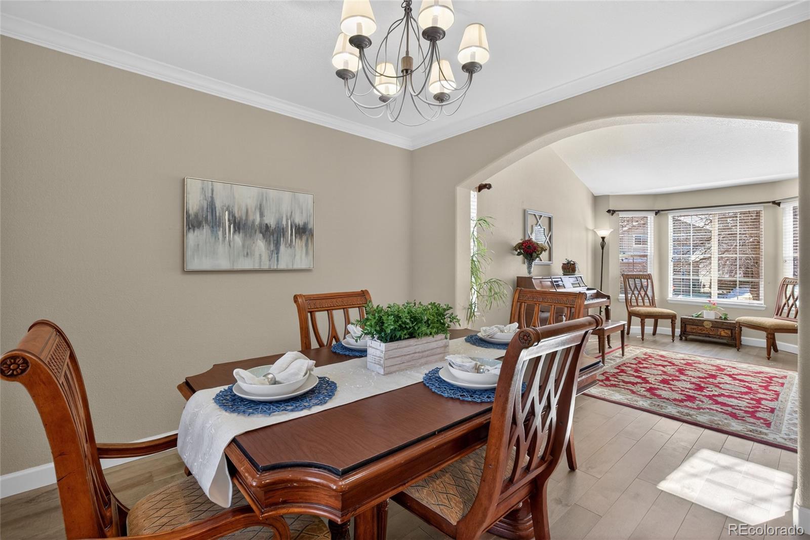 747 West Sparrow Hawk Drive Highlands Ranch, CO 80129 - Photo 5 of 50 a view of a dining room with furniture window and wooden floor