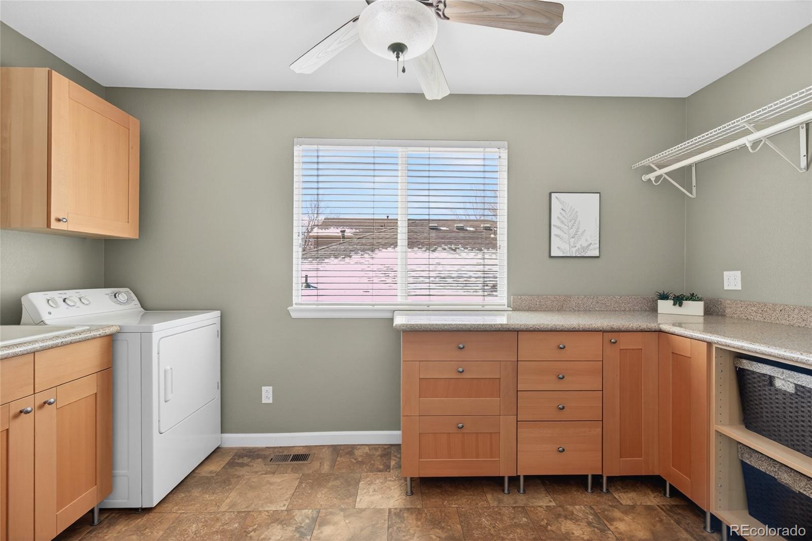 747 West Sparrow Hawk Drive Highlands Ranch, CO 80129 - Photo 10 of 50 a utility room with cabinets dryer and washer