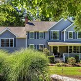 a front view of a house with garden and porch