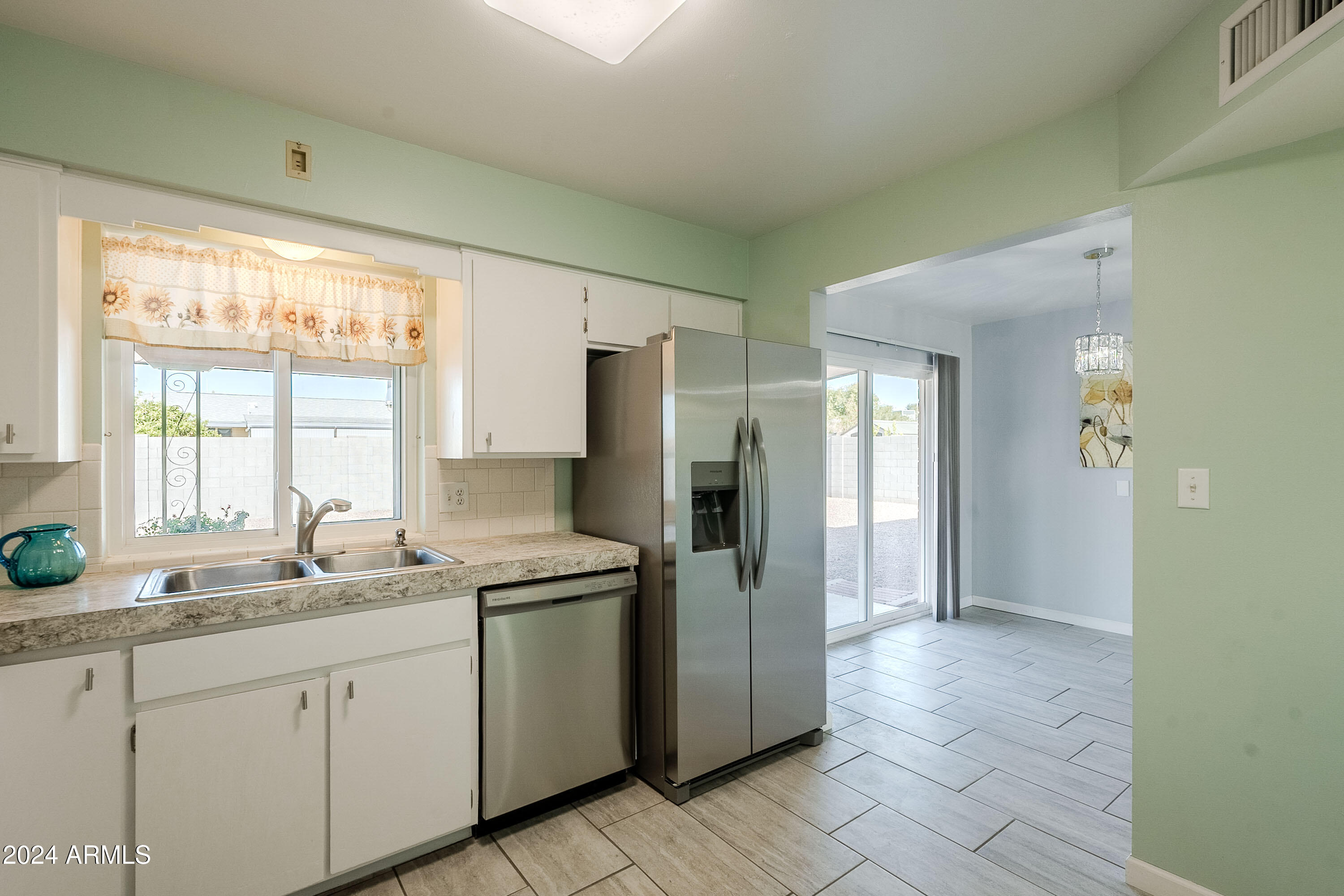 5914 East Decatur Street Mesa, AZ 85205 - Photo 5 of 37 a kitchen with stainless steel appliances granite countertop a refrigerator and a sink