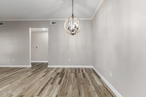 a view of a room with wooden floor fan and windows