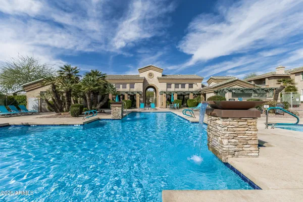 an outdoor space with swimming pool and furniture