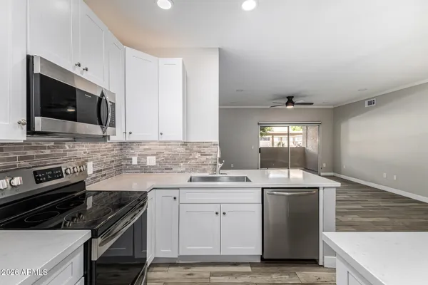 a kitchen with a sink stove and microwave
