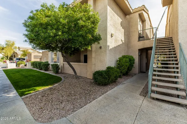 a view of front door of house with stairs