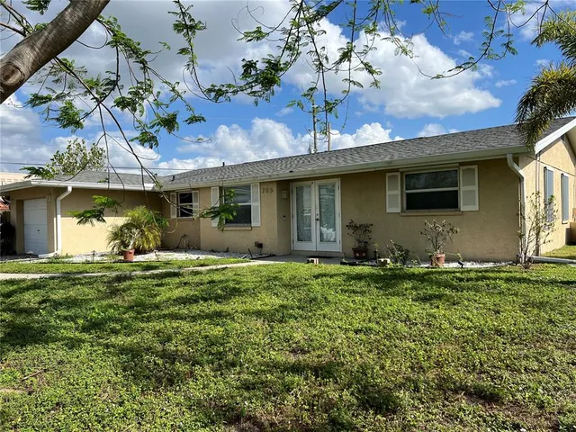 a backyard of a house with table and chairs