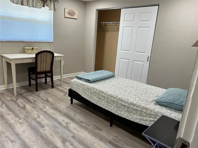 a bedroom with a bed and a chair