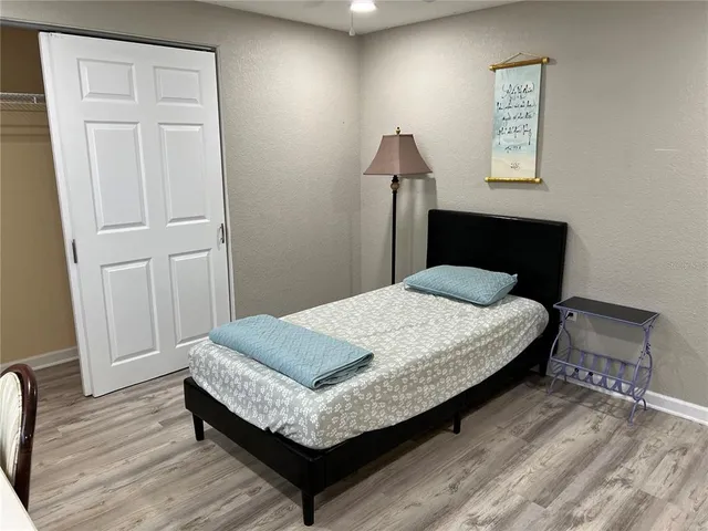 a bed sitting in a bedroom next to a window