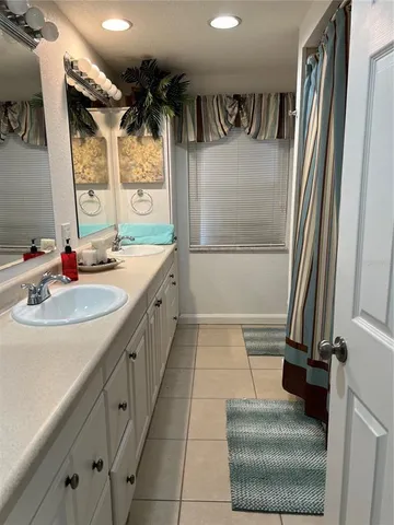 a bathroom with a double vanity sink and a mirror