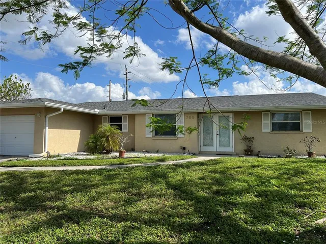 a front view of house with yard and outdoor seating