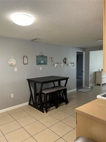 a living room with a table and a chair